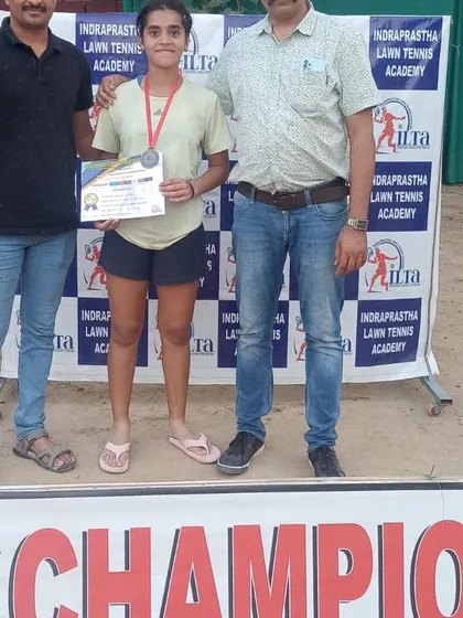 A champion from our tournament receiving her medal and certificate. We encourage players of all ages and genders to compete and excel.