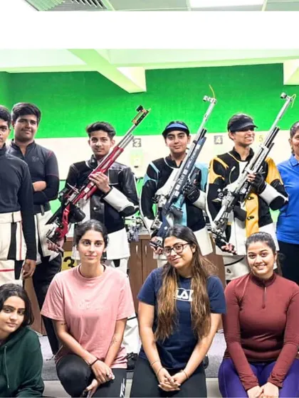 Our rifle shooters pose with their equipment and coaches during a training camp. We offer year-round programs to build consistency and performance under pressure.