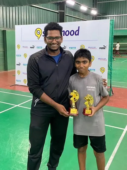 One of our star players with his coach and trophies from the Sporthood Badminton Juniors Tournament. We are committed to developing competitive athletes.