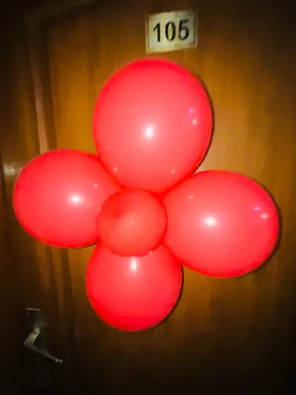 Even the smallest details matter. We place simple balloon decorations on the door to build anticipation before the big reveal.