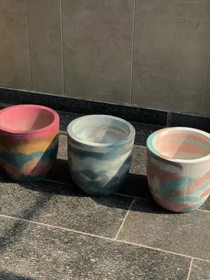 Our handcrafted concrete planters enjoying the golden hour. The marbled, multi-colored finish on each planter is unique, making them functional pieces of art for your home.