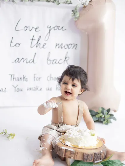 Let them eat cake! A first birthday cake smash is all about capturing pure, messy joy. This little one is having the time of his life during his minimalist-themed cake smash session at our studio.