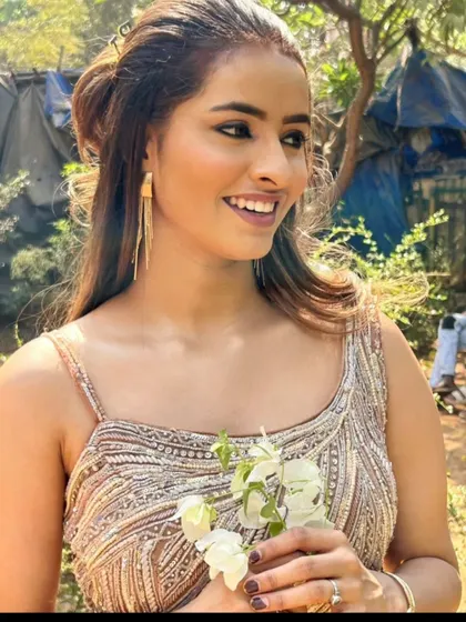 A candid outdoor shot of the model in the sparkling gown.