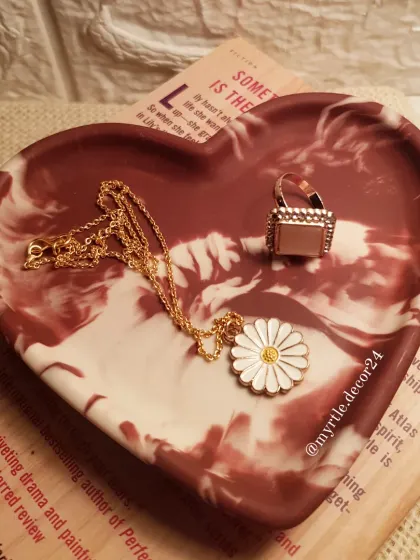 Our 'Aurora' heart tray styled with a book, showing how it can be a beautiful decorative object on its own, even when not holding jewelry.
