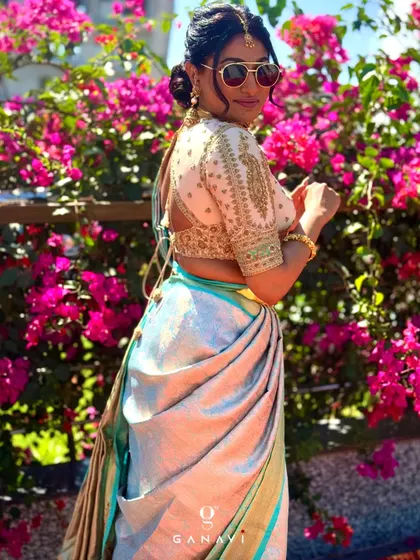 A beautiful client looking chic in a bespoke ensemble. The look features a signature embroidered blouse from my collection paired with a lustrous, light-colored saree.