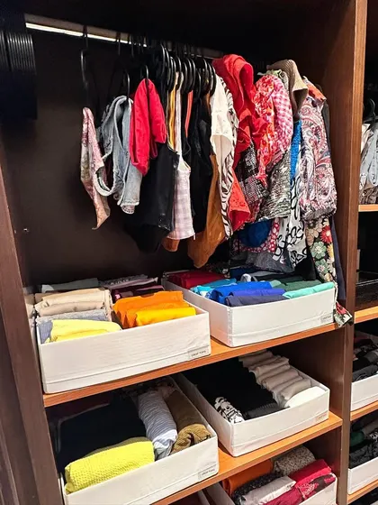 Here, we've used open-front bins to store folded items on shelves. This allows for easy visibility and access while keeping everything contained.