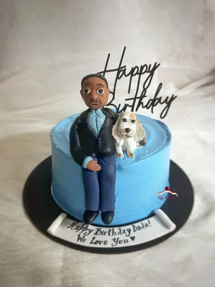A man and his dog. I made this special cake for my father-in-law, featuring a sugar figurine of him and his beloved furry best friend.