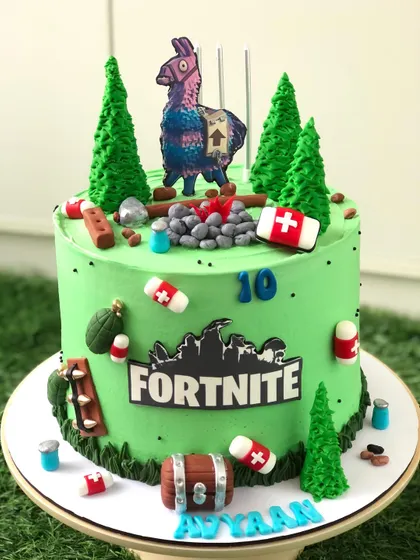 Level up! This Fortnite-themed cake features the iconic llama, a treasure chest, and other game elements on a vibrant green cake.