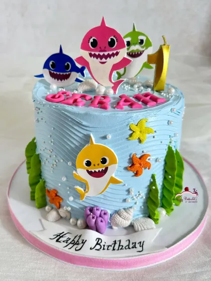 A Baby Shark cake for a first birthday, with the whole shark family.