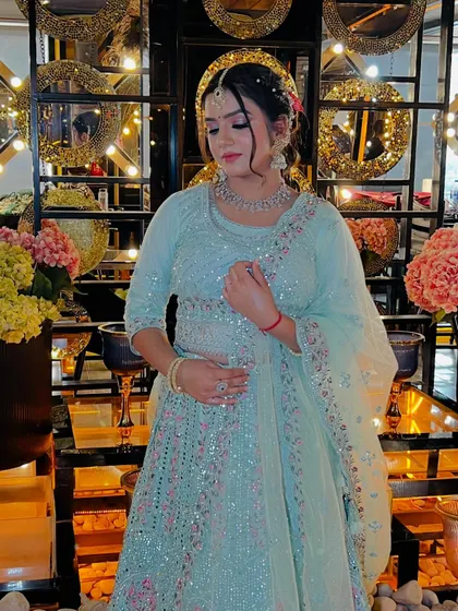 A full-length view of the pastel blue party look. The intricate embroidery on the lehenga is complemented by the soft, romantic makeup and hairstyle, creating a dreamy and ethereal vibe.