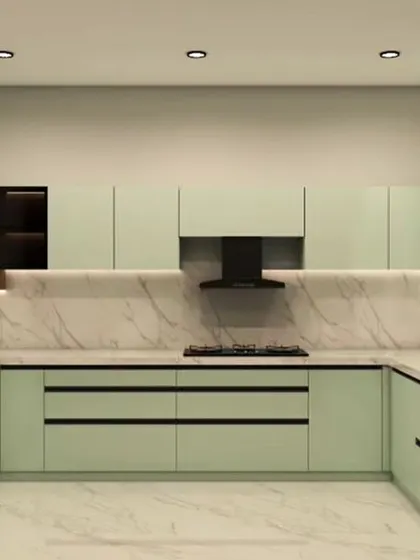 A serene U-shaped kitchen in a soft mint green. The handleless cabinets and marble backsplash create a clean, contemporary space that feels calm and refreshing.