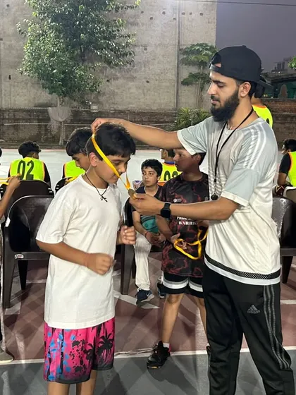 Awarding a medal to another deserving player. Recognizing effort is a core part of our coaching philosophy.
