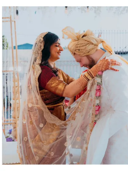 An intimate moment between the bride and groom, filled with affection and warmth. Our candid photography style focuses on capturing these unposed, emotional exchanges.