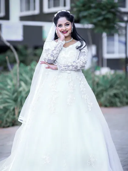 A classic white wedding gown with long lace sleeves and a full skirt. This piece was created by one of my talented students.