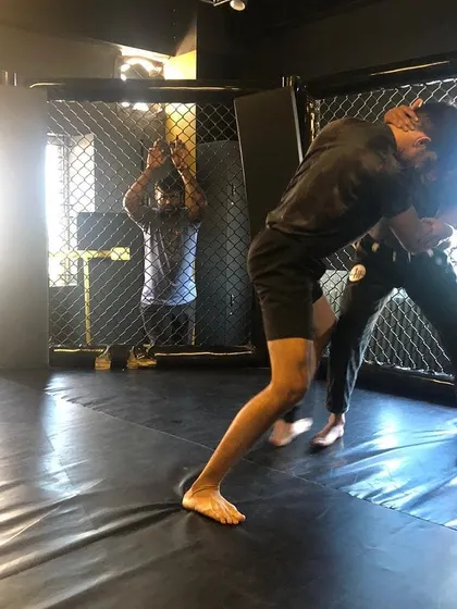 We use the cage to simulate real MMA scenarios. This shot from our BJJ Jam shows two members working on their wrestling and clinch game against the fence.