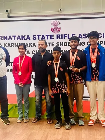 Our medal-winning team and coaches at the Karnataka State Shooting Championship. We believe in celebrating our collective successes as one strong unit.