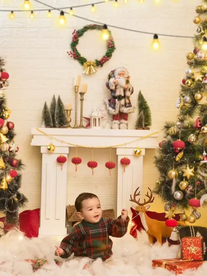 The wonder of Christmas in a child's eyes. This wide shot shows our full Christmas setup, complete with two trees, a fireplace, and lots of festive decorations.
