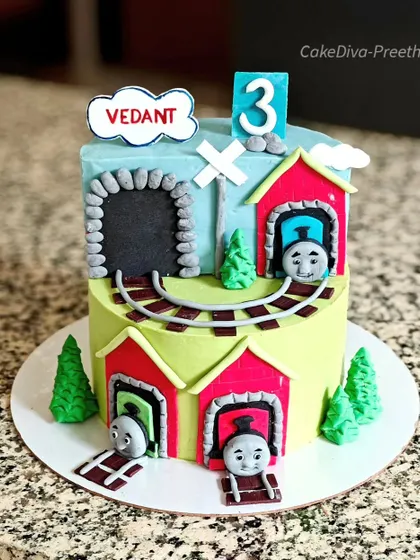 All aboard for a Thomas the Train party. This cake features Thomas and friends coming out of tunnels, with a fluffy vanilla sponge and blueberry filling inside.