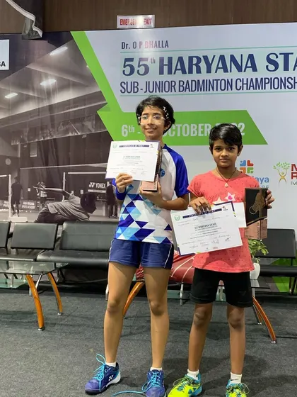 Nandini on the podium with her certificate and trophy after her U-11 singles win.