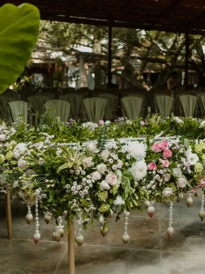 A beautifully decorated table, completely covered in fresh flowers and foliage.