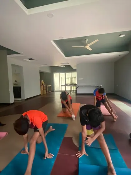 A forward fold is a great way for kids to stretch their hamstrings and learn to release tension in their backs. I guide them to breathe into the stretch, teaching them mindfulness from a young age.