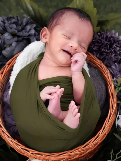 A precious moment of pure joy captured as this little one dreams. I focus on getting these fleeting smiles, which requires patience and a gentle touch, ensuring the baby is completely comfortable and happy.