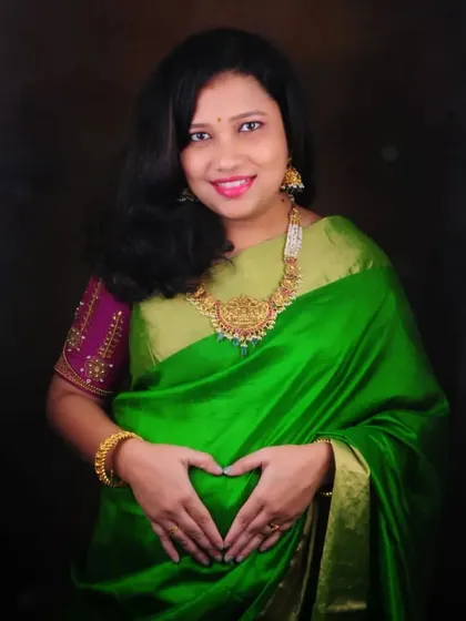 A beautiful maternity portrait. The client chose a simple temple necklace that adds a touch of tradition and elegance to her green saree.