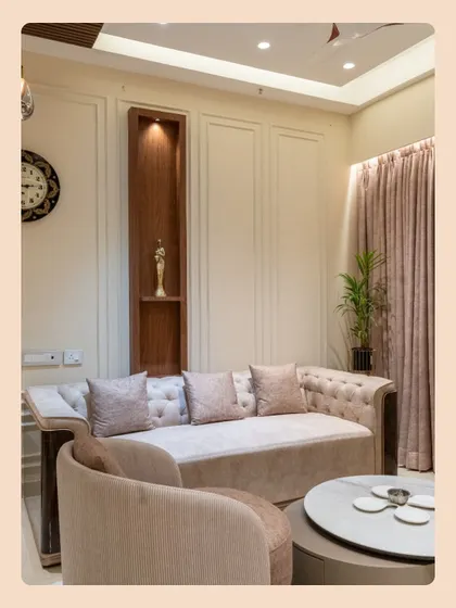 The seating arrangement is designed for conversation and comfort, with a mix of a classic tufted sofa and a modern accent chair in soft, neutral tones.