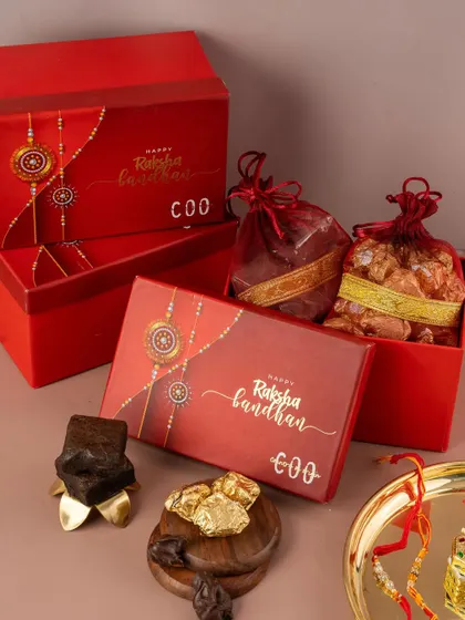 This shot focuses on the elegant packaging of a Rakhi gift box. We ensure that your branding is front and center in our festive photography.