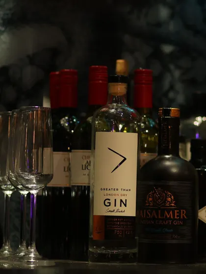 A shot of the well-stocked bar, focusing on premium gin bottles and glassware, adding to the sophisticated atmosphere of the event.