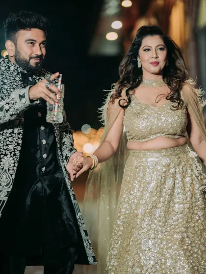The couple making a stylish entrance, hand in hand, ready to celebrate their Sangeet night.