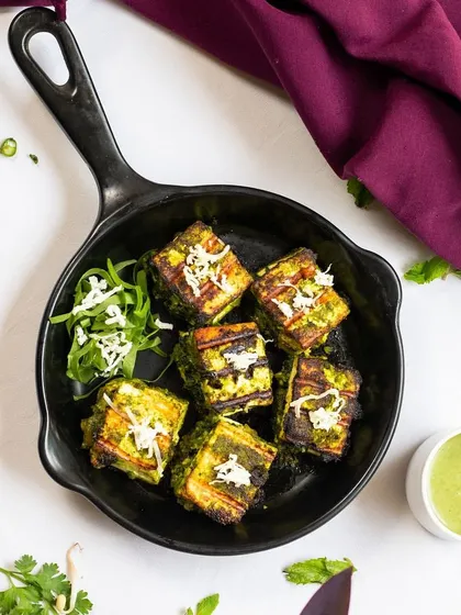 Delight in the vibrant flavours of my Hariyali Paneer Tikka, marinated with a blend of fresh herbs and spices for an irresistible taste that will keep you coming back for more.