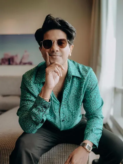 A portrait of Dulquer before the event. The vibrant green shirt has a great texture that looks fantastic on camera.