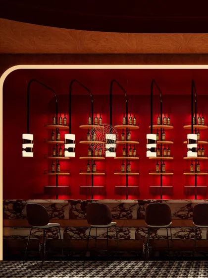 A render of the Koko suite's bar area, showcasing the deep red walls, custom shelving, and unique lighting designed to create an intimate and exclusive atmosphere.