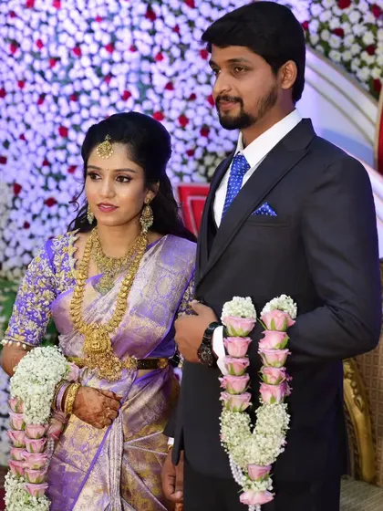 Sahana and her husband at their reception. Her makeup looks fresh and radiant, perfect for the celebratory atmosphere.