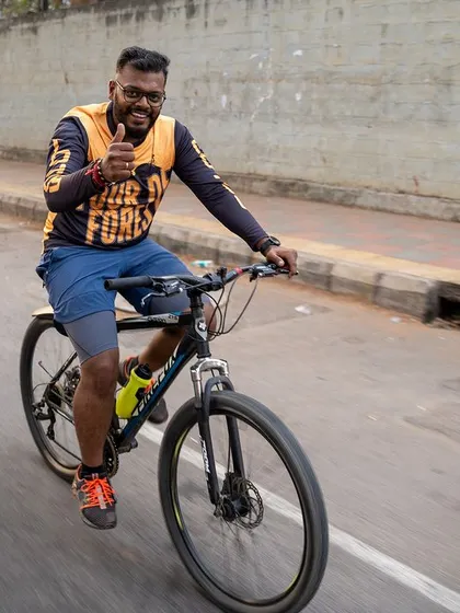 A happy cyclist gives a thumbs-up while enjoying the ride during our community event.