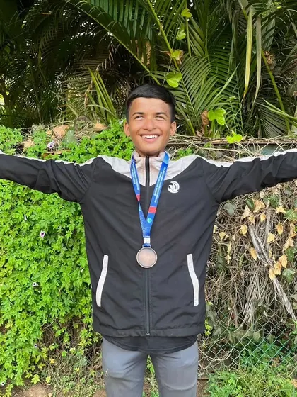 The joy of victory is clear on Piyush's face as he celebrates his 100m sprint achievement.