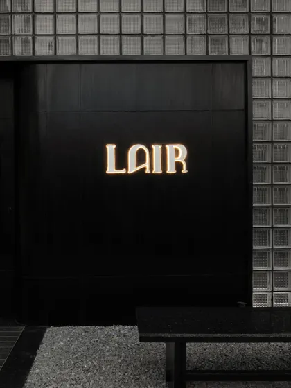A collection of atmospheric shots from Lair, showcasing the interplay of black concrete, glass blocks, polished steel, and dramatic lighting. Each image captures a fragment of the bar's mysterious and immersive character.
