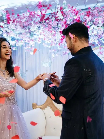 The ring exchange, captured amidst a shower of petals against a stunning cherry blossom-themed backdrop. A perfect blend of action and emotion.
