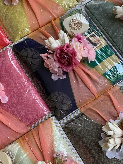 An overhead view of our engagement trousseau packaging, showing a variety of colors and floral arrangements.