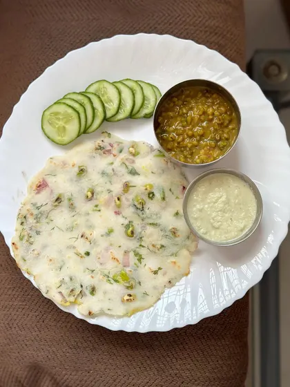 A healthy South Indian breakfast of akki roti, served with green gram dal, coconut chutney, and fresh cucumber.