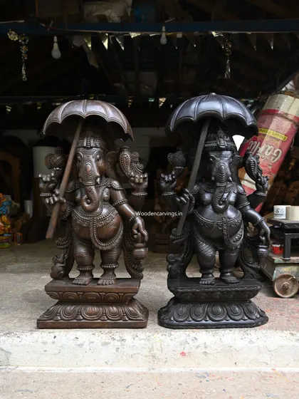 A comparison of the dark black and brown finishes on our 36-inch Umbrella Ganapathy statues.