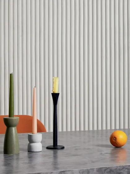 The 'Pilastre' wallcovering in a soft white, creating a clean and modern backdrop. The 3D texture adds a layer of interest that elevates the space beyond a simple painted wall.