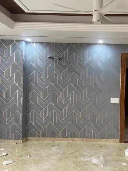 A sophisticated grey wallpaper with a repeating geometric arrow pattern. The metallic lines catch the light, adding a subtle shimmer and a touch of class to the room.