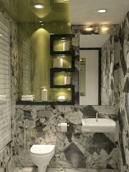 A luxurious bathroom fully clad in dramatic, large-patterned marble, with clever recessed shelving for storage.