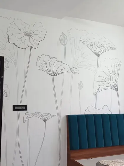 A minimalist bedroom with a delicate line-art floral wallpaper. The simple design adds an artistic and modern touch.