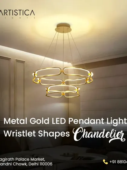 This metal gold LED pendant light features interlocking wristlet shapes, offering a modern and artistic statement. It provides a warm, ambient glow, perfect for suspension over a dining table or in a chic living area.