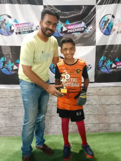 A player receiving the Best Goalkeeper award at the Andheri Premier League.
