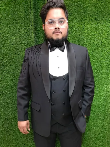 This customer is ready for his party in our black tuxedo. The subtle yet stylish embroidery on the shoulder gives it a designer touch without being too loud.