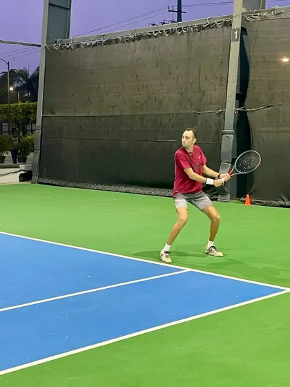 A coach demonstrates proper form during a practice session, showcasing the hands-on approach of our training staff.